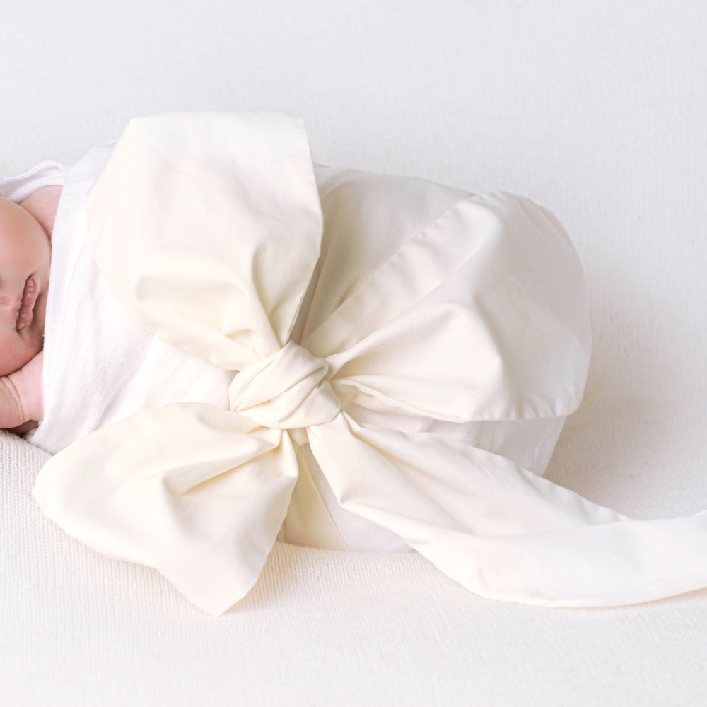 TBBC cream colored bow swaddle